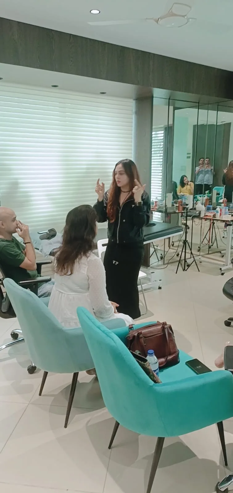 Vibha Jain standing and guiding a small group through a focused attention exercise in a practice room.